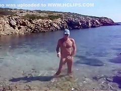 A hot day spent naked at the beach cums to a horny end