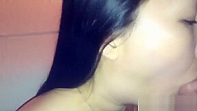 Asian girl makes a professional blowjob