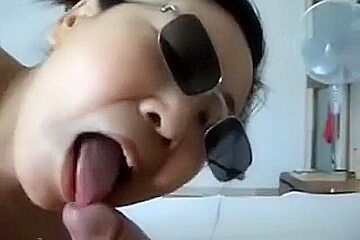 Asian girl with sunglasses sucks cock, while getting fingered 