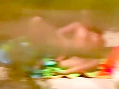 Babe masturbates spying on beach
