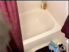 Big titted brunette stripping and showering on