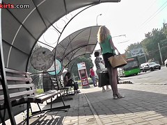 Blonde waits for a bus in the upskirt outdoor scene