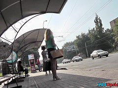 Blonde waits for a bus in the upskirt outdoor scene