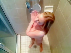 Busty babe gets caught on tape washing her voluptuous tanned body
