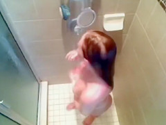 Busty babe gets caught on tape washing her voluptuous tanned body