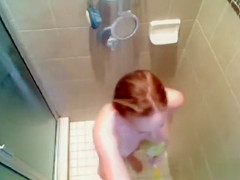 Busty babe gets caught on tape washing her voluptuous tanned body
