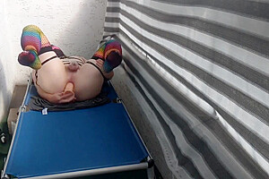 Caged Sissy Plays With Her Dildo On Public Balcony
