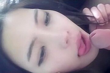 Chinese chick sucking a hard strapon