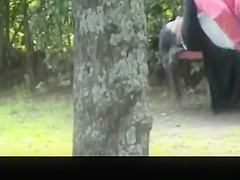 Dude fingers pussy in the public garden