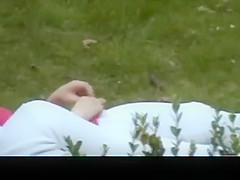 Dude fingers pussy in the public garden