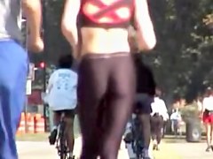 Girl in short top and tight pants running in the street 04i