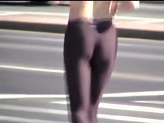 Girl in short top and tight pants running in the street 04i