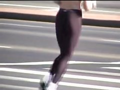 Girl in short top and tight pants running in the street 04i