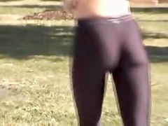 Girl in short top and tight pants running in the street 04i