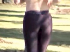 Girl in short top and tight pants running in the street 04i