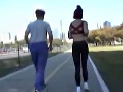 Girl in short top and tight pants running in the street 04i