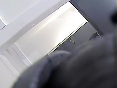Girl with long legs tries on dress in the changing room