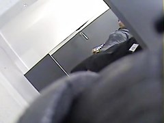 Girl with long legs tries on dress in the changing room