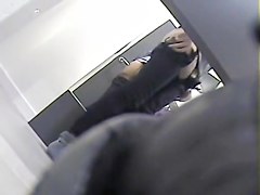 Girl with long legs tries on dress in the changing room