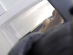 Girl with long legs tries on dress in the changing room