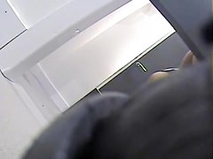 Girl with long legs tries on dress in the changing room