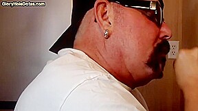 Homemade gloryhole DILF sucks and wanks cock in closeup