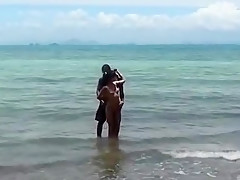 Hot naked brunette touching herself at the beach
