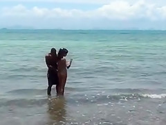 Hot naked brunette touching herself at the beach