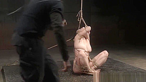 Inked babe punished in hogtie bondage
