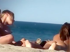 Lesbian girls sunbathe with their natural tits out