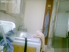 Mature drying off and dressing after her shower