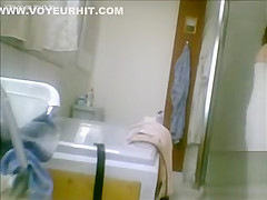 Mature drying off and dressing after her shower