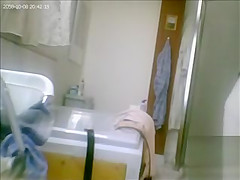 Mature drying off and dressing after her shower