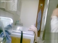 Mature drying off and dressing after her shower