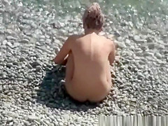 Nude woman and her man refreshing in the water