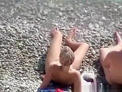 Nude woman and her man refreshing in the water