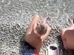 Nude woman and her man refreshing in the water