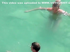 Nude woman and her man refreshing in the water