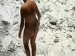 Nudist woman has her pussy fingered in the beach