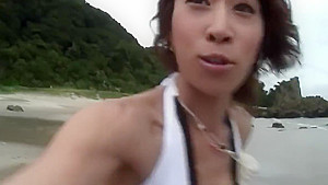 Randy brunette sucks guy's pole on the beach