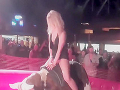 Seductive blonde rides the mechanical bull