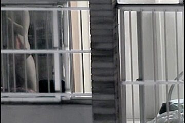 Sexy naked neighbor is staying in front of the open window