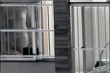 Sexy naked neighbor is staying in front of the open window
