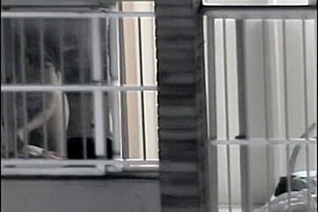 Sexy naked neighbor is staying in front of the open window