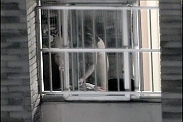 Sexy naked neighbor is staying in front of the open window