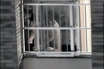 Sexy naked neighbor is staying in front of the open window