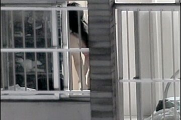Sexy naked neighbor is staying in front of the open window