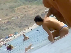 Sexy topless babe in a thong bikini