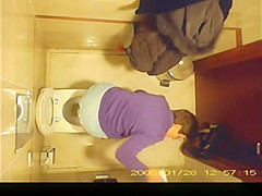 Short hair mature woman taking a pee