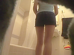 Slender girl rubs lotion on her hot body